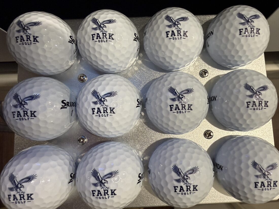 A dozen premium golf balls printed with the navy FARK Golf eagle line illustration