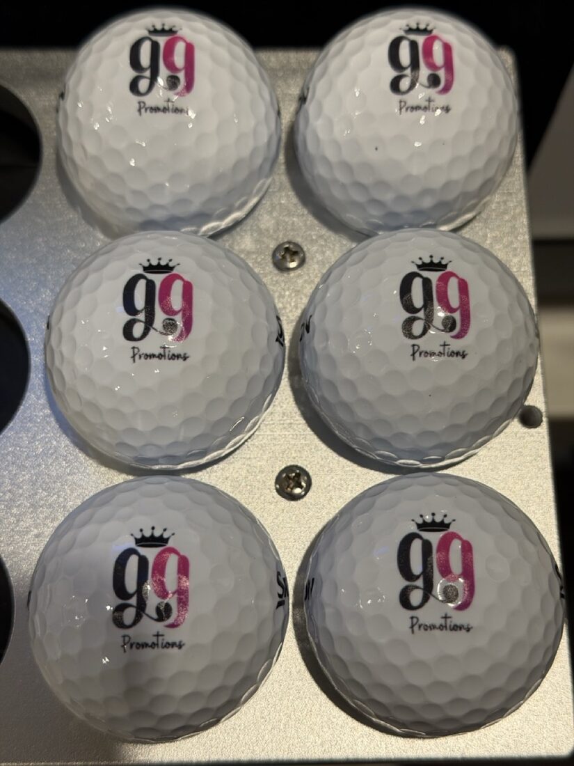 Golf balls printed with the pink and navy gg Promotions logo