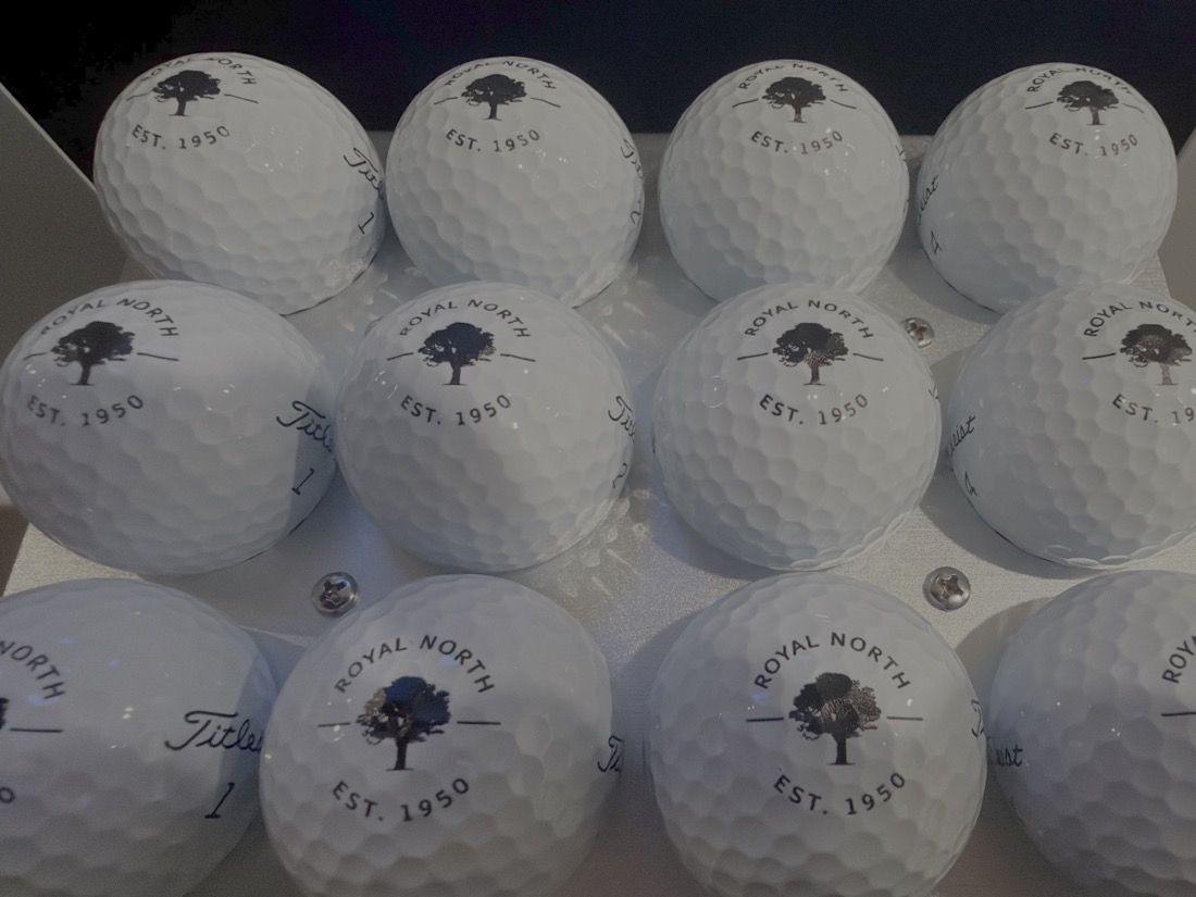 A dozen Titleist golf balls printed with the Royal North golf club crest